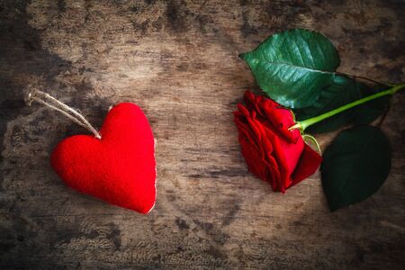 Red felt heart and rose on wood, valentine, mother's dayの写真素材