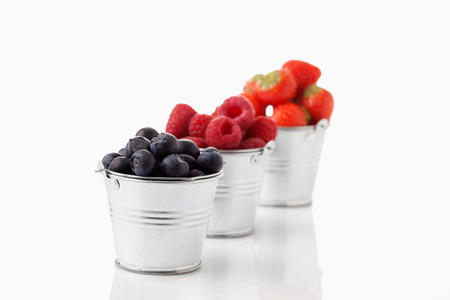 Zinc buckets with blueberries, strawberries and raspberriesの写真素材