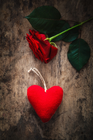 Red felt heart and rose on wood, valentine, mother's dayの写真素材