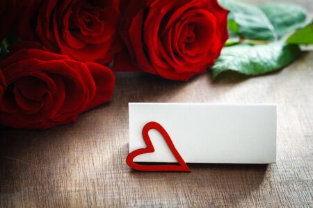 Name tag in front of hearts and rosesの写真素材