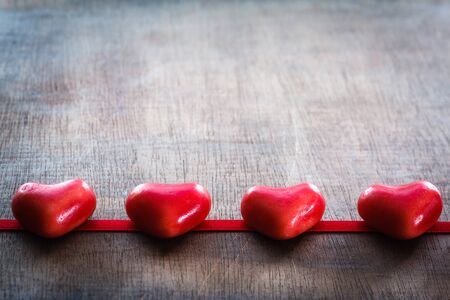 Red sugar hearts on wooden backgroundの写真素材