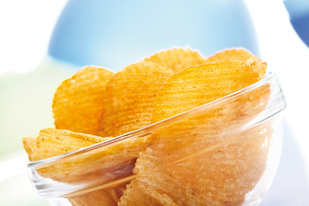 Potato chili chips in bowl, close-upの写真素材