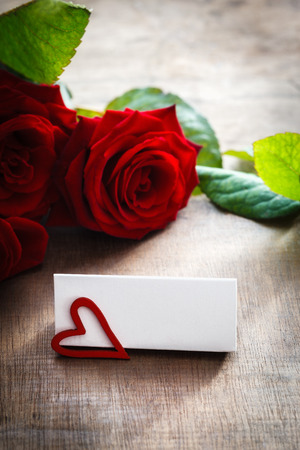 Name tag in front of hearts and rosesの写真素材