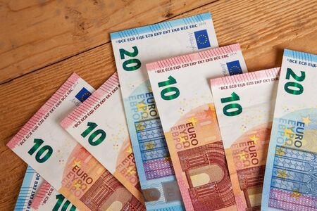 Banknotes on wood, twenty and ten Euro notesの写真素材