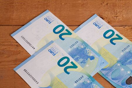 Banknotes on wood, twenty Euro notesの写真素材