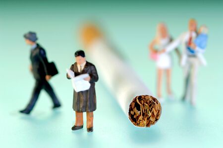 Various figurines next to cigaretteの写真素材