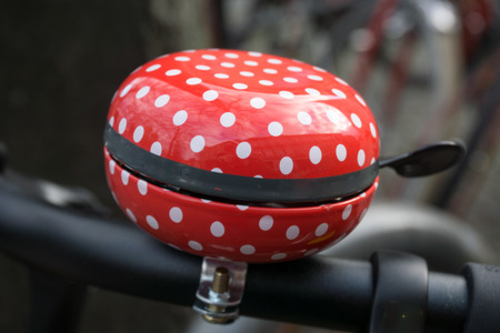 Bicycle bell with white polka dots on redの写真素材