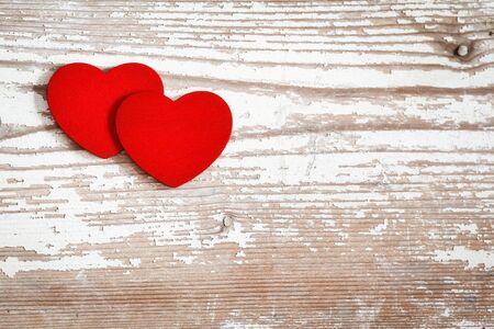Two red hearts on woodの写真素材