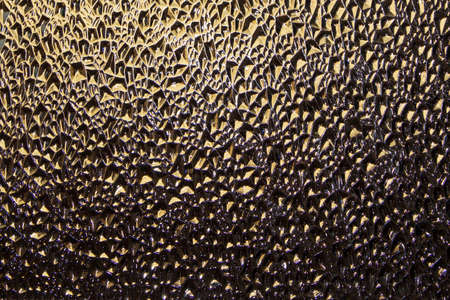 Translucent Glass Close-up Surface with Refractive Light. Uneven Bumpy Semitransparent Texture Backgroundの写真素材