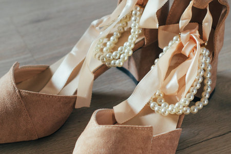 pair of wedding shoes with atlas laces and pearls decoration