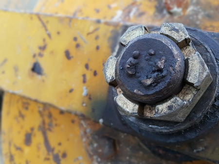 Yellow concrete mixer's lock nut with rust and greaseの写真素材