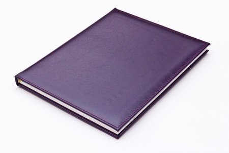 purple notebook isolated on white backgroundの写真素材