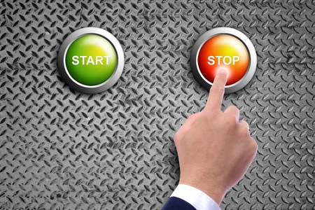 hand pushing stop button on diamond steel backgroundの写真素材