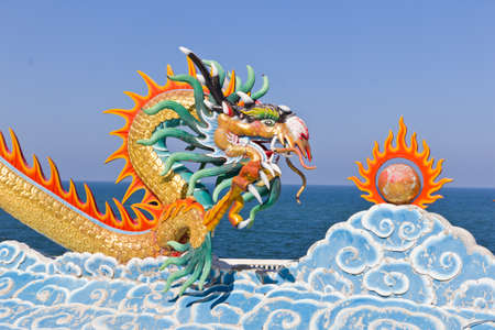dragon statue against blue sky in chinese templeの写真素材