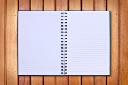blue notebook on wood backgroundの写真素材