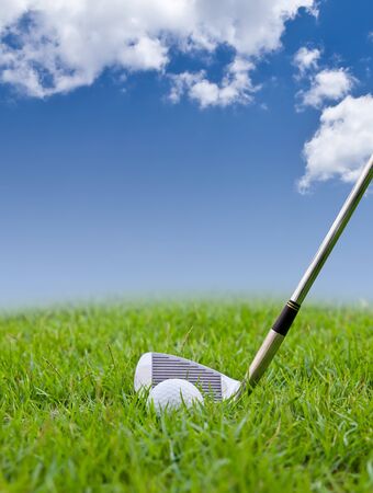 golf ball and iron on tall grassの写真素材