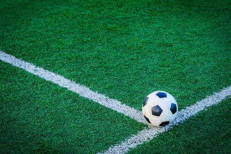 soccer ball on green grassの写真素材