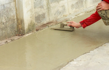 hand pastering cement mortal on the floorの写真素材
