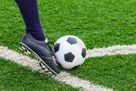 foot kicking soccer ball on cornerの写真素材