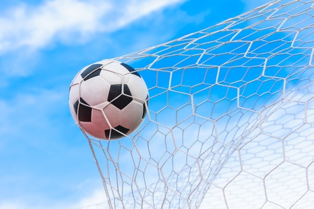 soccer ball in goal netの写真素材