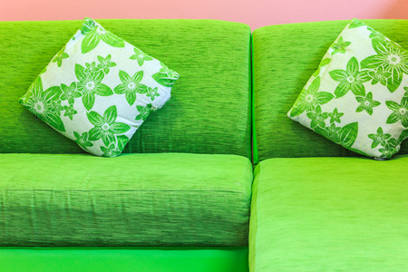 Green sofa in pink roomの写真素材