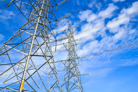 electricity high voltage power pylon against blue sky