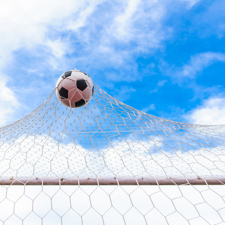 football in goal netの写真素材