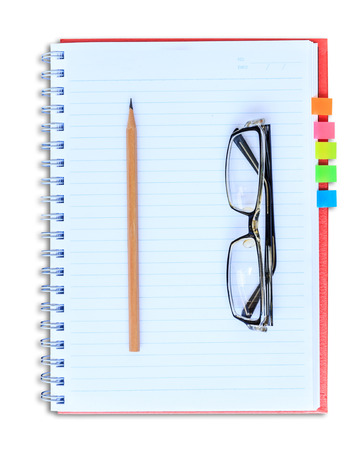 red notebook pencil and eyeglasses isolated on white background with clipping pathの写真素材