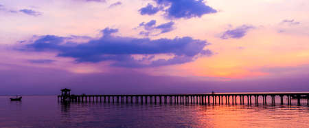 silhouette people driving bicycle on wood bridge with sunsetの写真素材