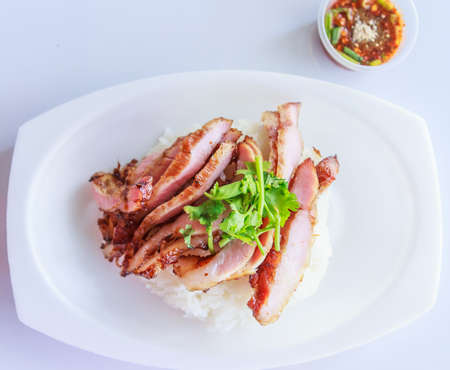 Grill pork with rice and spicy sauceの写真素材