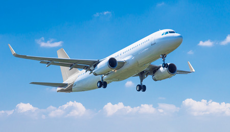 Commercial plane taking off against blue skyの写真素材