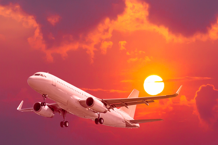 air plane flying with sunsetの写真素材