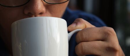 Drinking coffee in the morning with a white glassの写真素材