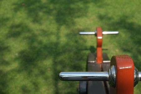The wooden totter has a stainless steel handle on the playground.の写真素材