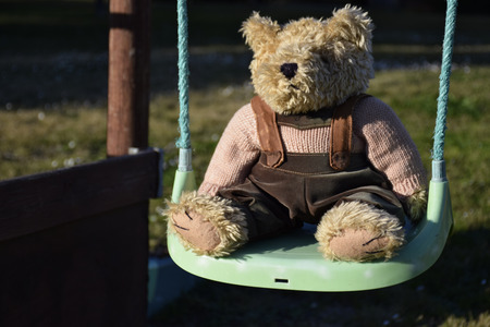 Teddy bear on the swingの写真素材
