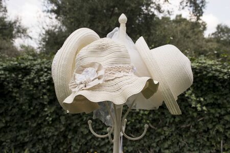 Straw hat on a coat rack in a garden. vintage imageの写真素材