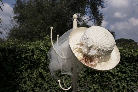 Straw hat on a coat rack in a garden. vintage imageの写真素材