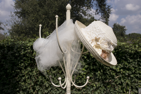 Straw hat on a coat rack in a garden. vintage imageの写真素材