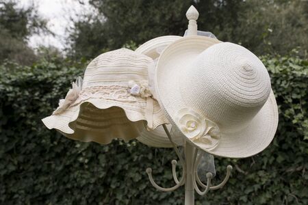 Straw hat on a coat rack in a garden. vintage imageの写真素材
