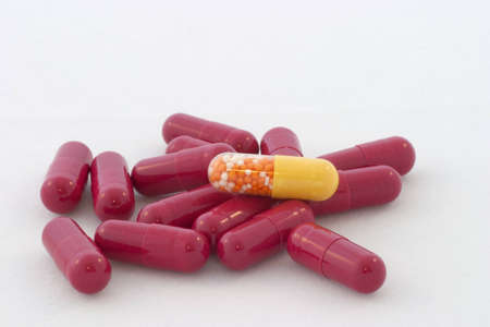 Red pile of pills with one yellow
