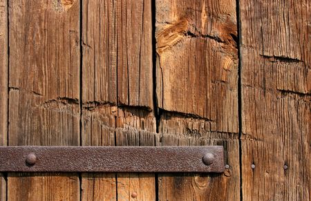 Old wood background texture. Vintage warehouse door and metal element. Rural architecture.の写真素材