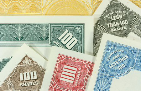 Colorful, authentic, old share certificates of American corporations. Vintage scripophily collectibles.の写真素材