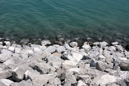 Water and stone coast - abstract background. Lake Minnewanka.