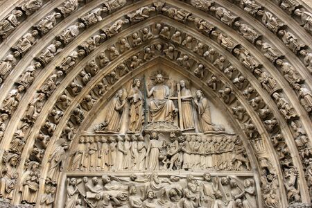 Decoration above the door of Notre Dame cathedral in Paris, Franceの写真素材