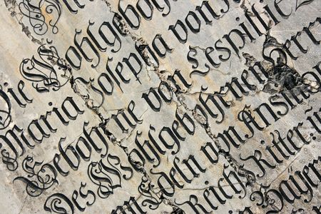 Vintage gothic script on a tomb. Mariendom church wall in Munich, Germany.の写真素材