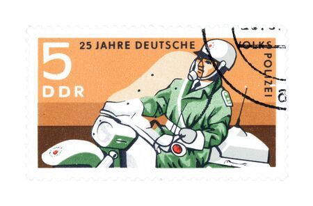 Collectible stamp from East Germany. Stamp with police officer on motorcycle.の写真素材