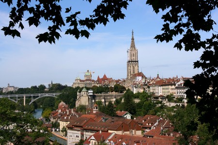 Bern, Switzerland. Beautiful old town. Prominent cathedral tower. Kirchenfeld Bridge on the left.