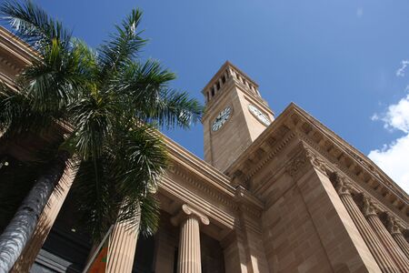 Brisbane city hall and a palm tree. Summer day.の写真素材