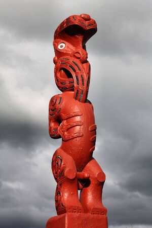 Maori carving - red figure carved in the wood. Rotorua, New Zealand.の写真素材