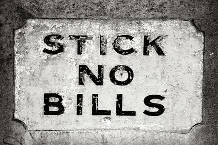 Grungy old sign on the wall - stick no bills. Detail in London, UK.の写真素材